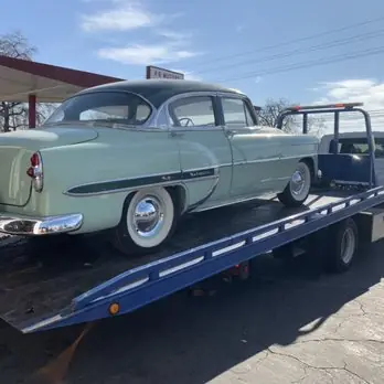 Mint green classic sedan on a flatbed
