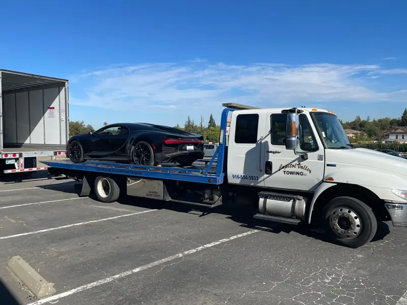 Bugatti Chiron on a white flatbed in a parking lot