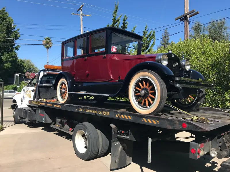 Antique red classic car on a flatbed
