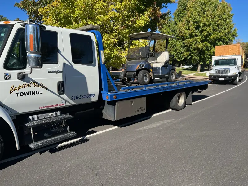 Golf cart on a flatbed tow truck
