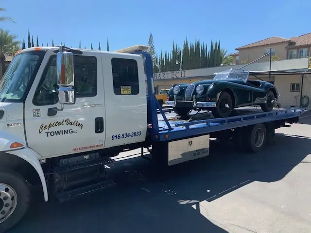 Classic Jaguar roadster on a flatbed