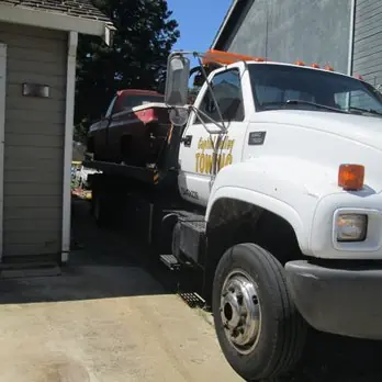 Tow truck picking up an old car