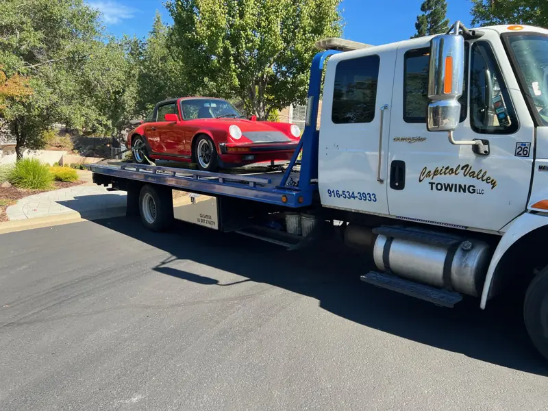 Red Porsche on a Capitol Valley Towing flatbed