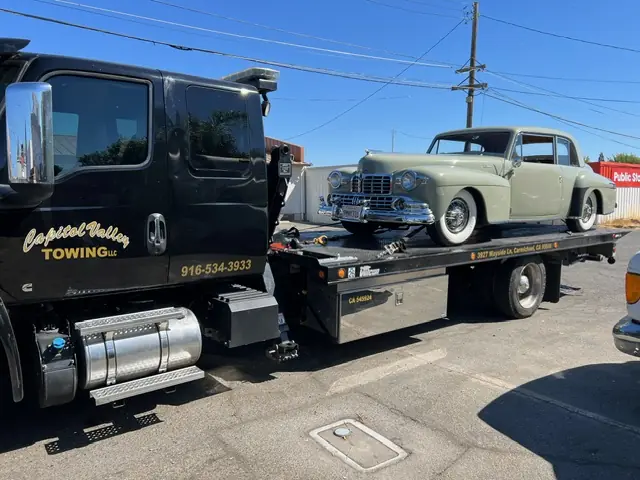 Capitol Valley black tow truck at a car show